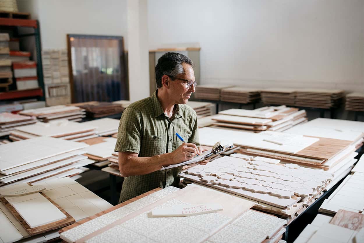 worker managing tile clipboard Pratt + Larson